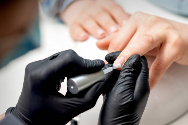 istock Manicure master applying transparent varnish 1282815278