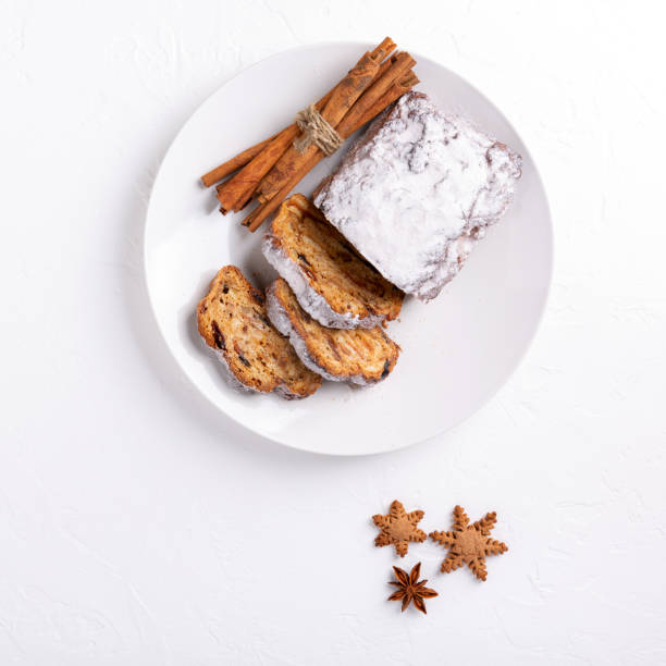 bolo tradicional de natal stollen no fundo branco. pão de frutas com nozes, especiarias e frutas secas. vista superior. - christmas stollen christmas pastry baked - fotografias e filmes do acervo