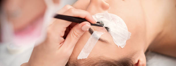 istock Woman receiving eyelash extensions procedure 1282815345