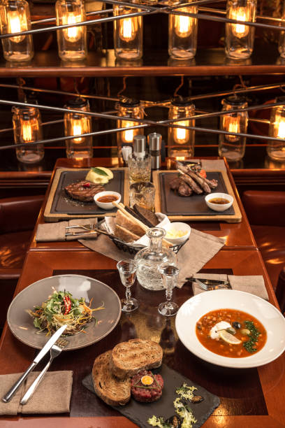 istock Gourmet meals assorted set on wooden table Buffet at restaurant with light bulbs 1282817167