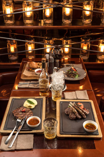 istock Gourmet meals assorted set on wooden table Buffet at restaurant with light bulbs 1282817221