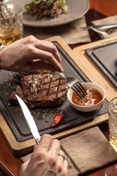 istock man eating steak with mashed potato and tomato sauce at restaurant 1282817506