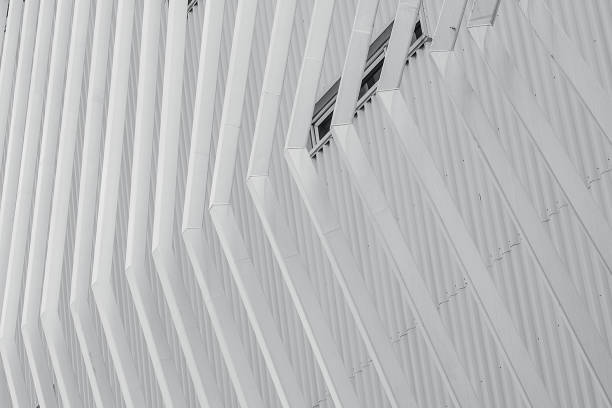 istock White facade building abstract background. Modern futuristic facade building. Steel cladding corrugated metal sheet facade of building. Exterior building wall architecture. Facade pattern design. 1282817597