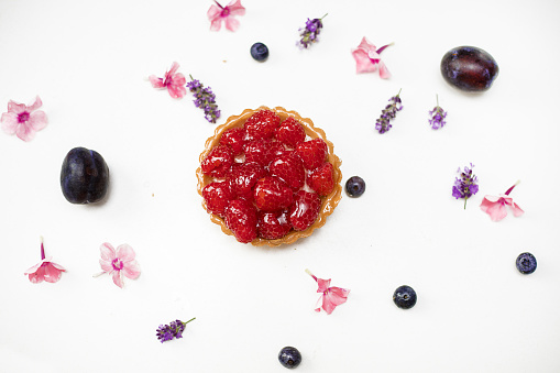 Delicious fresh dessert tartlet of shortbread decorated with fresh Raspberry. The concept of baking bakery, sweet food. Close-up photo, isolated, copy space. flat lay