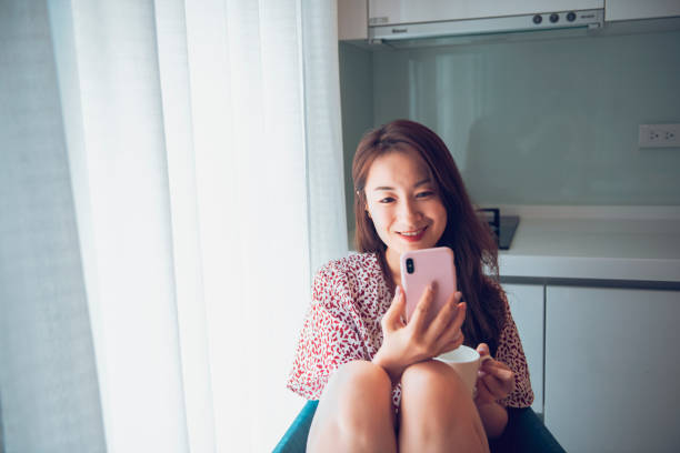 istock Asian Women using phone at home 1282820098