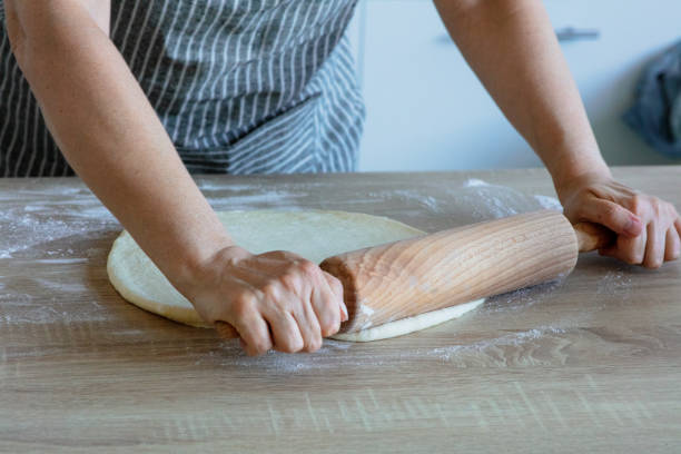 istock roll out the yeast dough with a wooden dough roller 1282820197