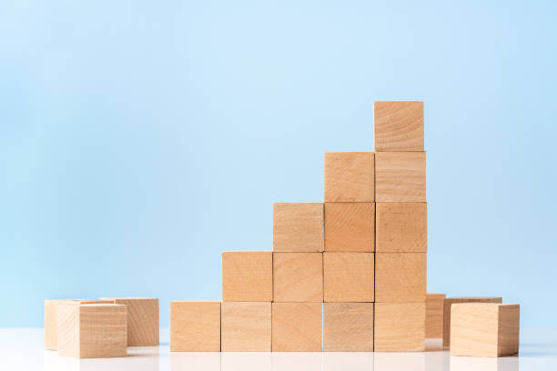 istock Wooden blocks as increasing graph bar on blue background 1282820203