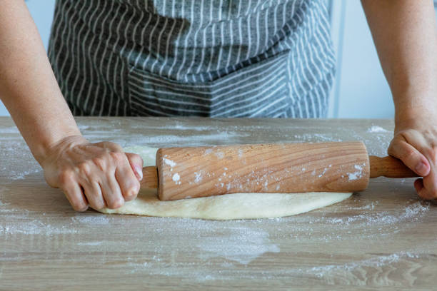 istock roll out the yeast dough with a wooden dough roller 1282820222