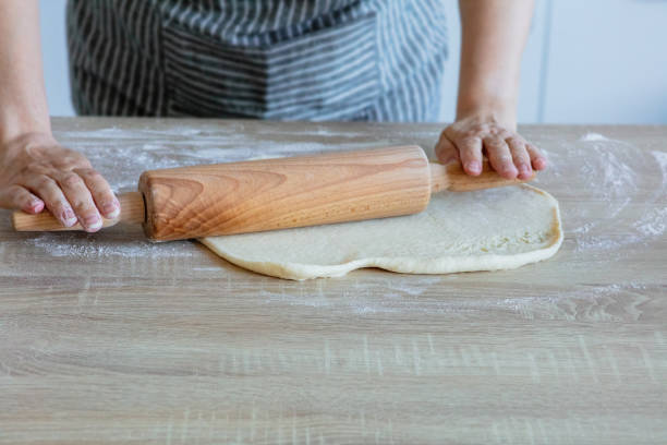 istock roll out the yeast dough with a wooden dough roller 1282820243