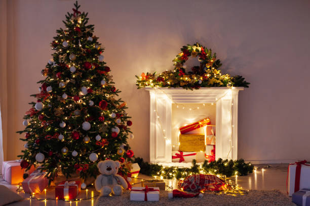 istock Christmas tree pine with gifts light garlands interior decor new year 1282820320
