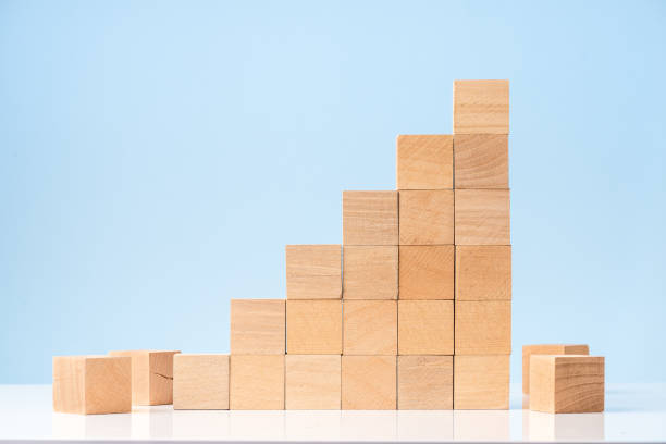istock Wooden blocks as increasing graph bar on blue background 1282820325