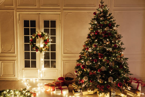 istock Light garland Christmas tree decor presents new year night interior 1282821253