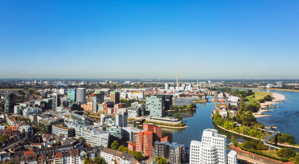 aerial view of Düsseldorf media harbor with Rhine river aerial view over Düsseldorf skyline with Rhine river and media harbor on blue sunny day düsseldorf stock pictures, royalty-free photos & images