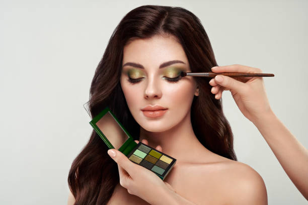 istock Makeup artist applies eye shadow 1282822537