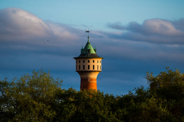 istock Watertower in Mannheim Germany, trees, dark sky clouds 1282822593