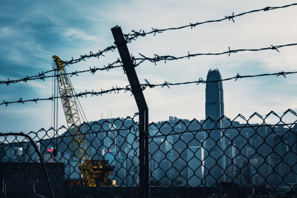 istock Cityscape outside barbed wire fence 1282823028