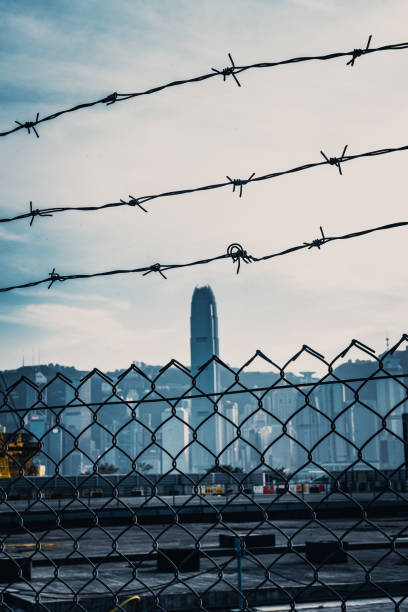 istock Cityscape outside barbed wire fence 1282823088