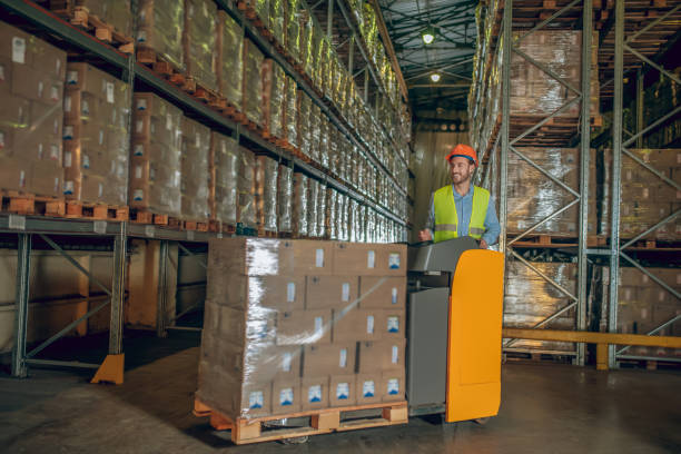 istock Male warehouse worker in helmet standing at the megastore 1282823512
