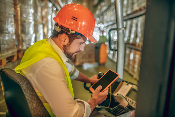 istock Young bearded worker watching something on the tablet and looking interested 1282823532