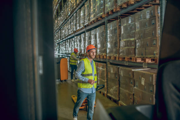 istock Worker in a yellow vest and helmet looking busy 1282824163