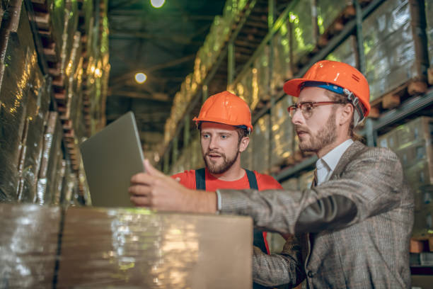 istock Warehouse worker and manager checking the data on the laptop 1282824374