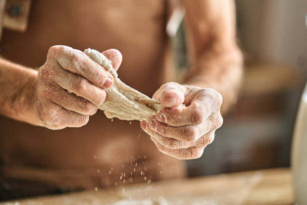 istock Male hands holding homemade dough while cooking at home 1282826081