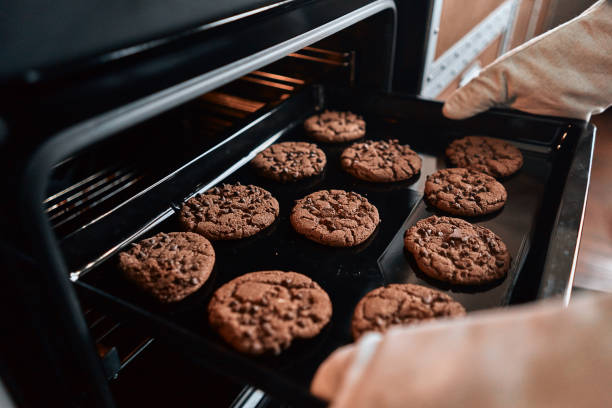istock Chef in oven-gloves preparing pastries in the oven 1282826099