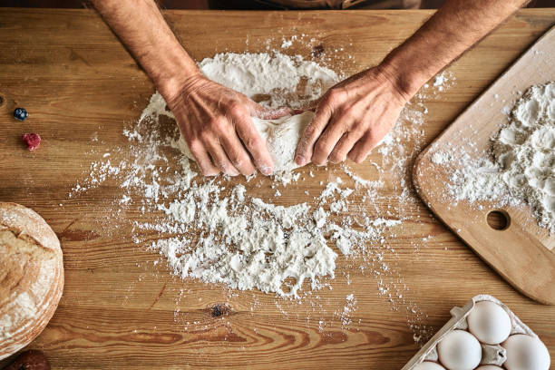 istock Close up of man preparing bread dough 1282826100