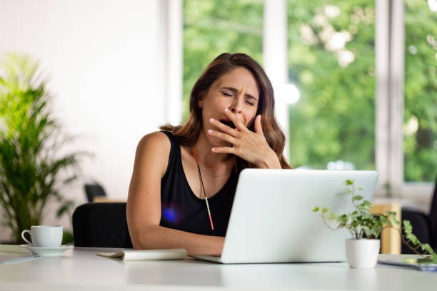 istock Tired young woman working on computer in the green office 1282826656