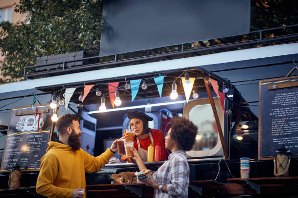 istock friends having a toast with a employee in front  fast food 1282828121