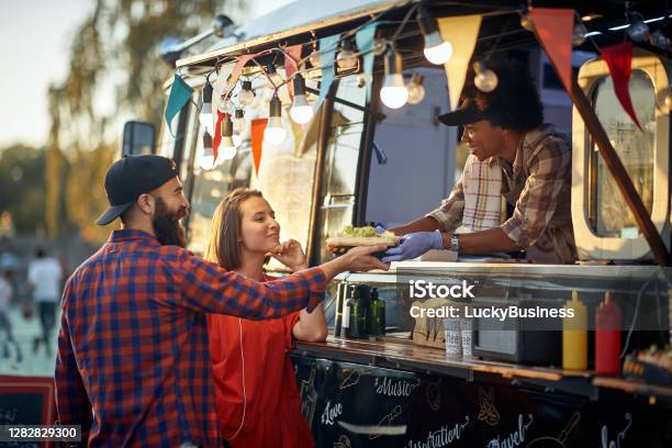 Satisfied Couple Taking Ordered Sandwiches From An Polite And Friendly Employee Stock Photo - Download Image Now