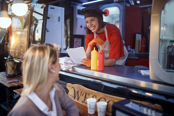 istock young satisfied  female talking to customer who is  leaving 1282829398