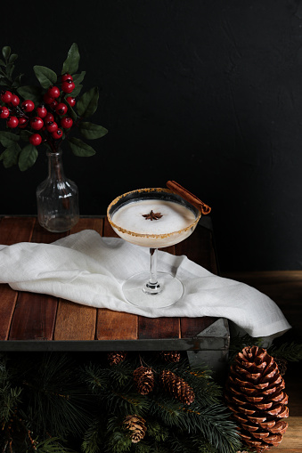 Winter Gingerbread Cocktail with elegant moody look on rustic wood table.