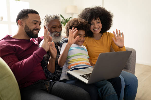 istock Multi generation family waving while having a video call on laptop at home 1282830506