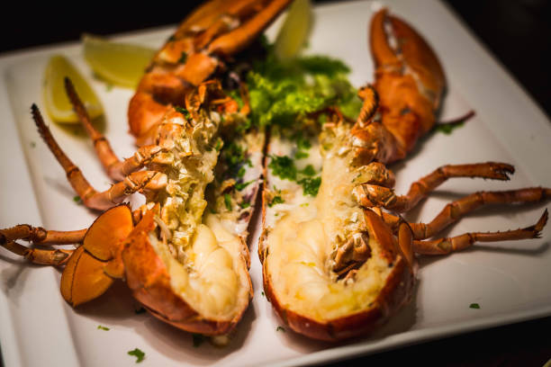 istock a whole grilled lobster cut in half and served with lemon wedges 1282830630
