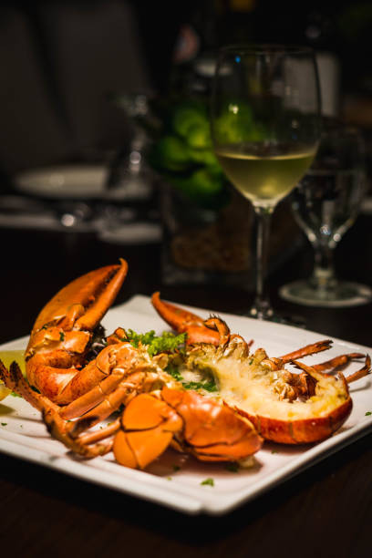 istock a whole grilled lobster cut in half and served with lemon wedges 1282830719