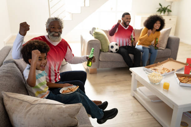 istock Multi generation family cheering while watching sports on TV 1282830772