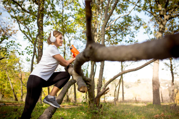 istock Disabled woman walking down and training outdoors in forest 1282830878