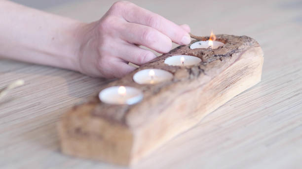 istock human hand lighting the candle. Praying, faith, religion concept. selective focus 1282831735