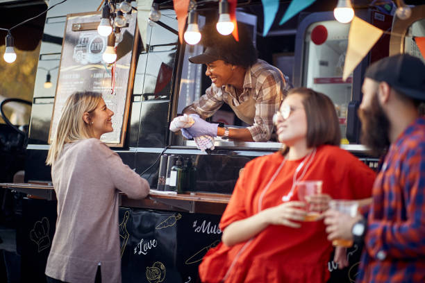 istock employee having conversation with a customer, smiling, with another couple standing by, talking 1282831766