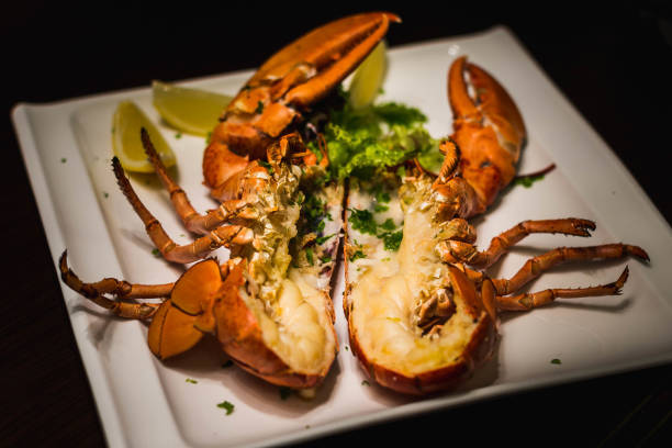 istock a whole grilled lobster cut in half and served with lemon wedges 1282831846