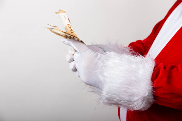 istock Santa Claus holds money on white background with copy space 1282831920