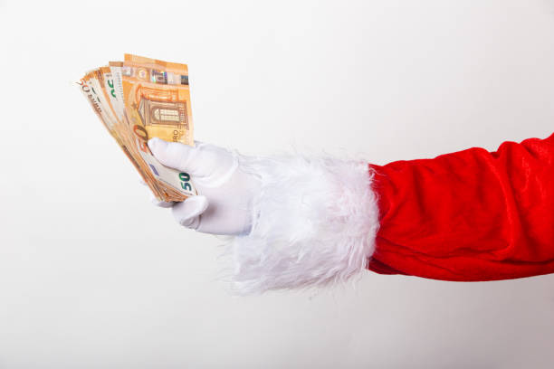 istock Santa Claus holds money on white background 1282831930
