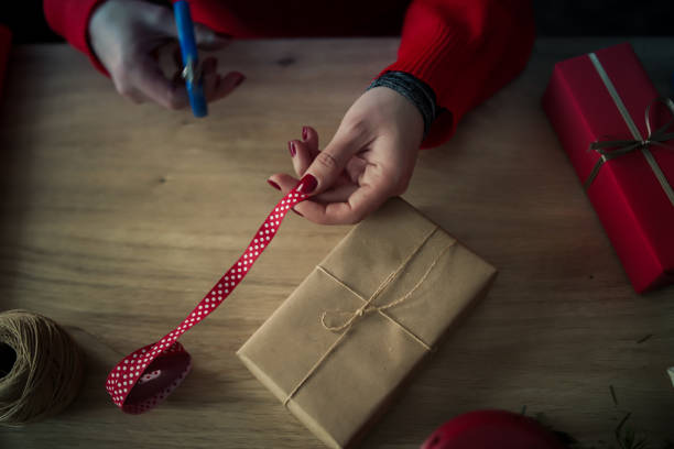 istock Female hands decorating Christmas gift box 1282832461