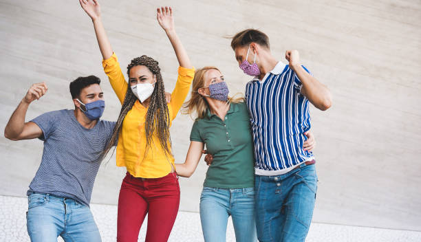 istock Young people having fun around city street during coronavirus outbreak - Main focus on blond girl face 1282834780