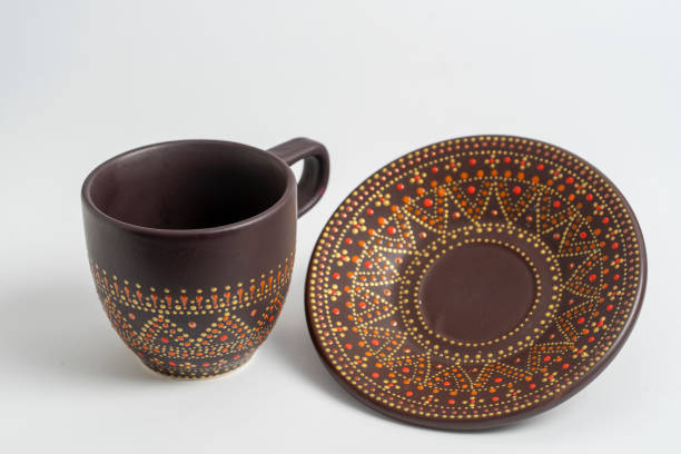 istock Decorative ceramic painted cup and saucer on white background, close up 1282837157