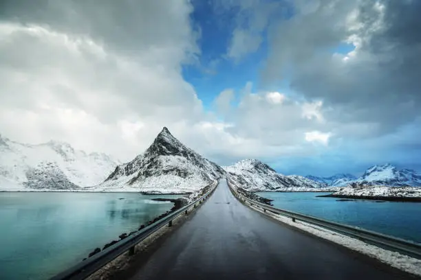 Olstind Mount and asphalt road. Lofoten islands, spring time, Norway