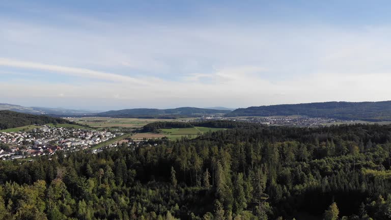 Rotating view over Habsburg forest, fields, hills, little villages in canton Aargau, Switzerland.