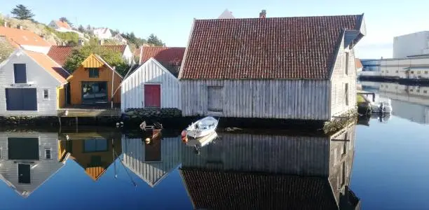 Reflections of the boathouses!  The old town Skudeneshavn in Karmøy Island, Norway is known as "Summer town" . With many wooden houses and boathouses, it is one of the best preserved towns in Europe