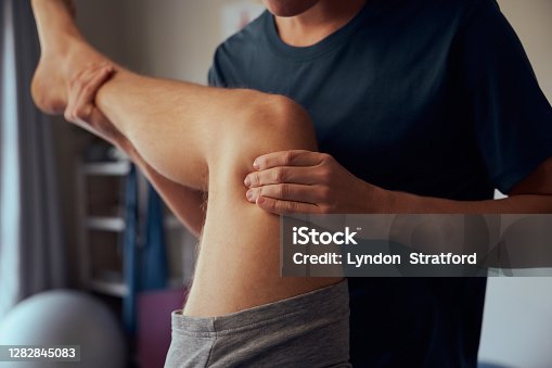 istock Closeup of physiotherapist hands giving therapy treatment to patient 1282845083